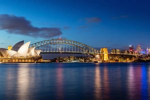 Sydney skyline at twilight. Panorama of the Sydney Skyline. The Sydney Opera House small on the left side, Sydney Harbour Bridge in the middle. Twilight Scenic Sydney Panorama. Sydney, Australia. Canon 5DSR 50MPixel Panorama.